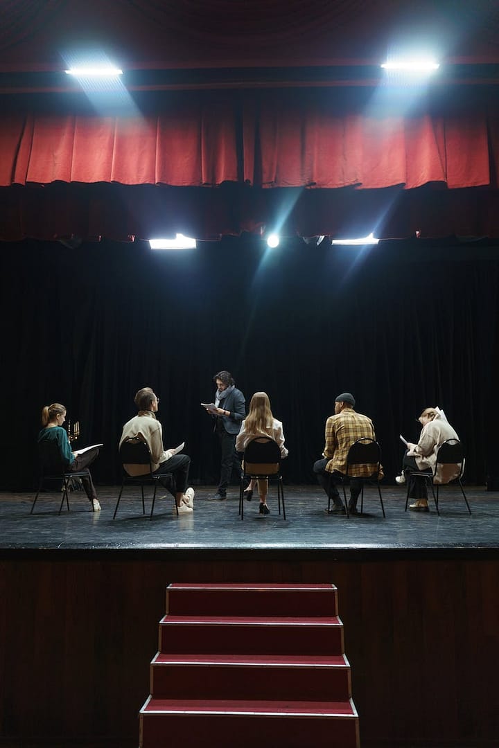 group of people sitting on chair on stage